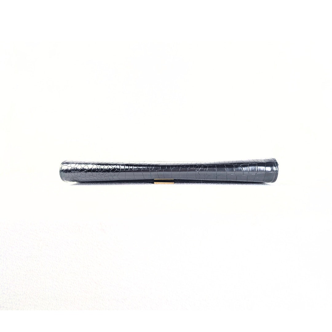 The bottom of the Ted Baker Crocodile Embossed Leather Envelope Evening Clutch Bag, captured on the white background. 