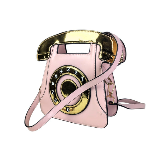A pink and gold phone-shaped crossbody handbag with a faux leather exterior and a rotary dial design on the front.